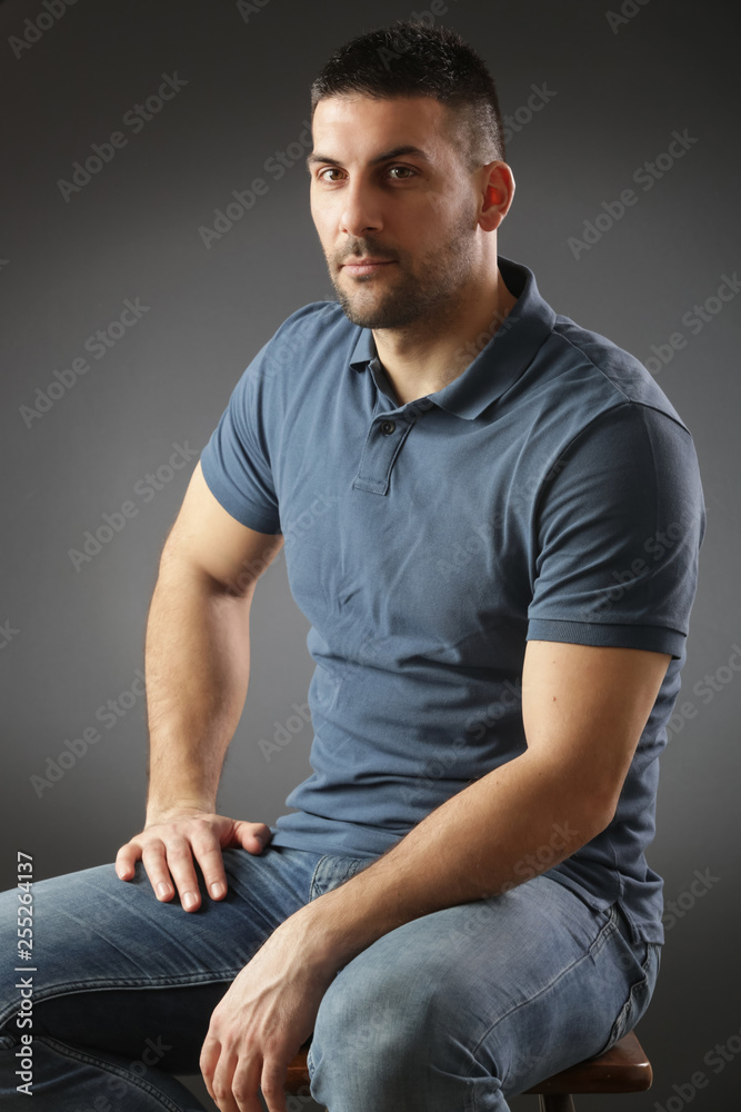 Portrait of young man looking at camera, studio shot on the grey background Portrait of young man looking at camera, studio shot on the grey background