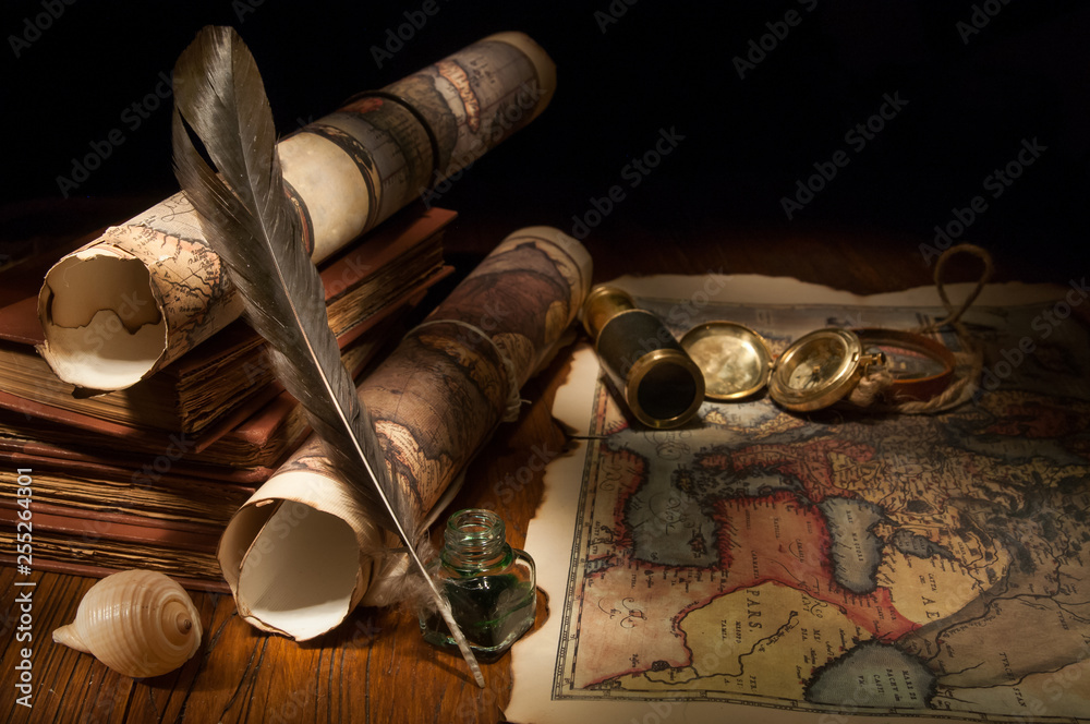 Vintage still life: old maps and vintage objects on a wooden table