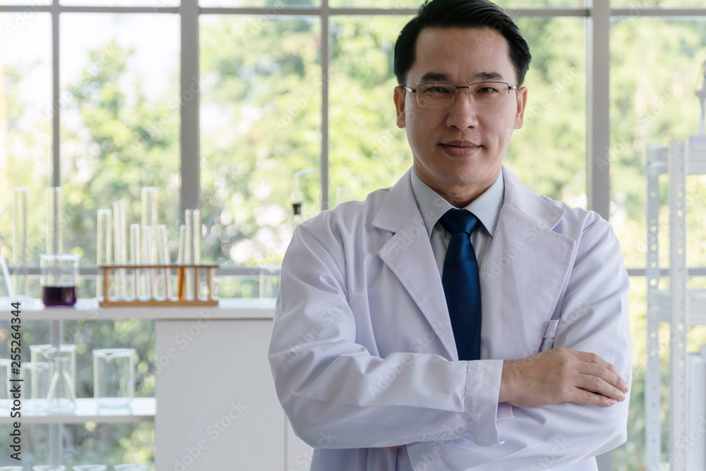 Researchers wear white coat with glasses arms crossed looking camera in the laboratory. Researchers wear white coat with glasses arms crossed looking camera in the laboratory.