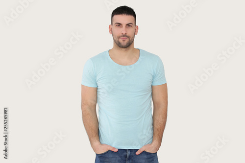 Studio portrait of a handsome bearded man in a blue t-shirt © triocean