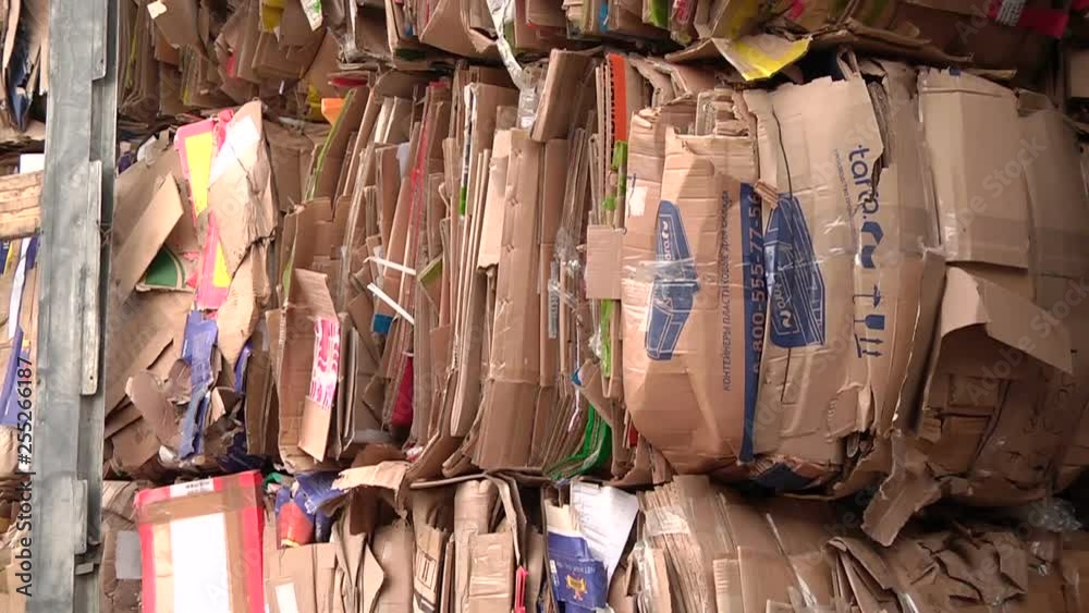 The cardboard packaging is compressed and prepared for recycling