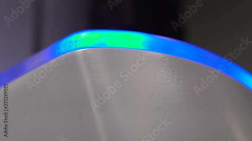 Closeup Insert: Blue light flashes on medical device in medical setting.