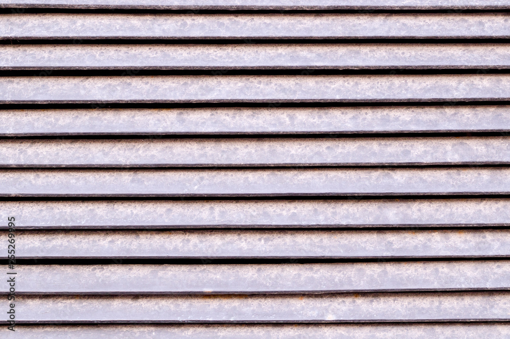 horizontal stripes of dusty metal jalousie exterior. background, texture. horizontal stripes of dusty metal jalousie exterior. background, texture.