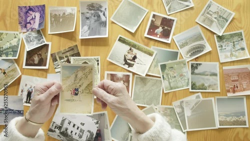 Top view of a senior caucasian woman looking at old photos themes of memories nostalgia photos retired photo
