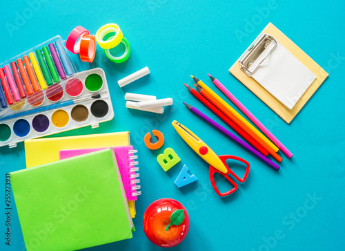 Stationery for study at school lies on blue. Back to school. Rainbow color