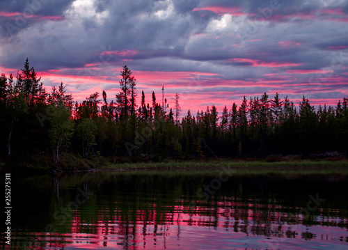 A Canadian sunset turns the clouds pink in northern Saskatchewan photo