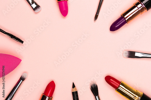 Beauty and makeup products frame on pink background