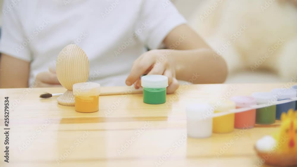 Creative boy is making craft, opening a red paint. Creative boy is making craft, opening a red paint.