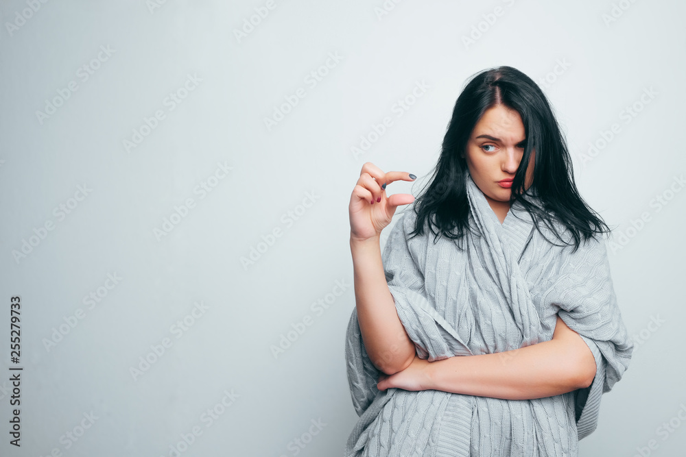 Funny excited woman showing something very tiny little size by fingers, happy girl with open mouth amazed by small prices looking at camera isolated on white grey studio background Funny excited woman showing something very tiny little size by fingers, happy girl with open mouth amazed by small prices looking at camera isolated on white grey studio background