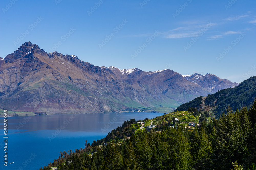 peaceful landscape during sunny day with calm sky above the lake and mountain range peaceful landscape during sunny day with calm sky above the lake and mountain range