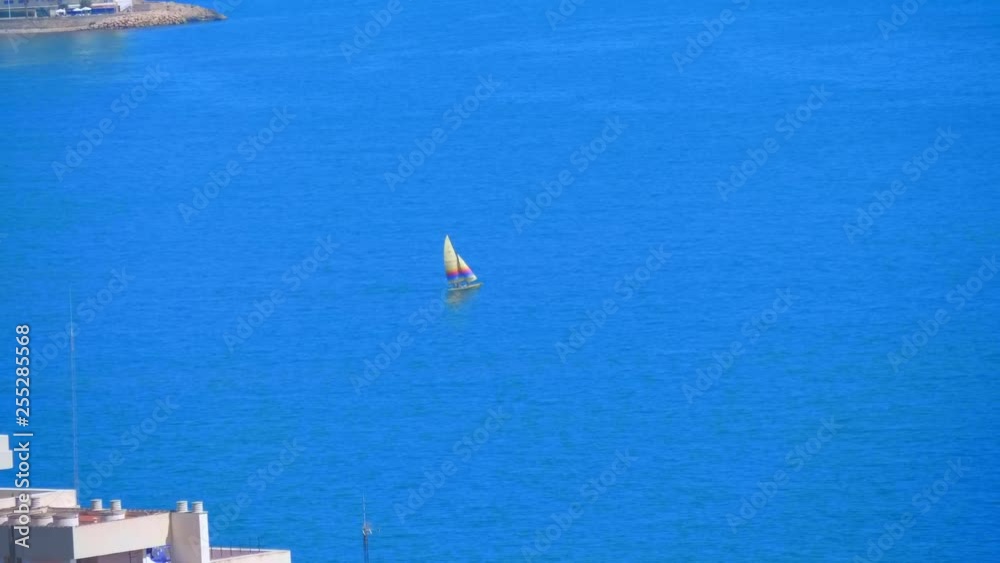 Sailing yacht sails to the endless expanses of the blue Mediterranean Sea, sailing from the resort town of Spain Sailing yacht sails to the endless expanses of the blue Mediterranean Sea, sailing from the resort town of Spain