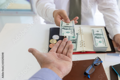 Business and finance concept, Hand of a businessman giving money to his partner.