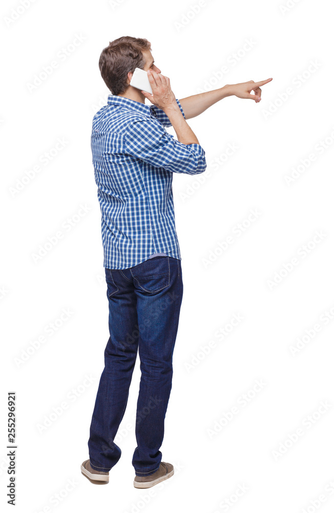 Back view of pointing young men talking on cell phone. Back view of pointing young men talking on cell phone.