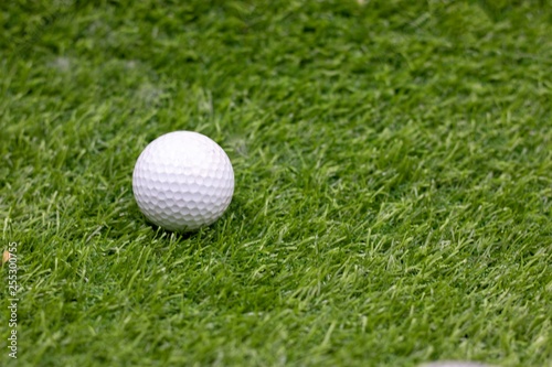 one golf ball is on green grass