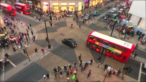 Time lapse of Oxford circus and regent street junction with rush hour traffic of both pedestrians, cars and Red double deck buses.
