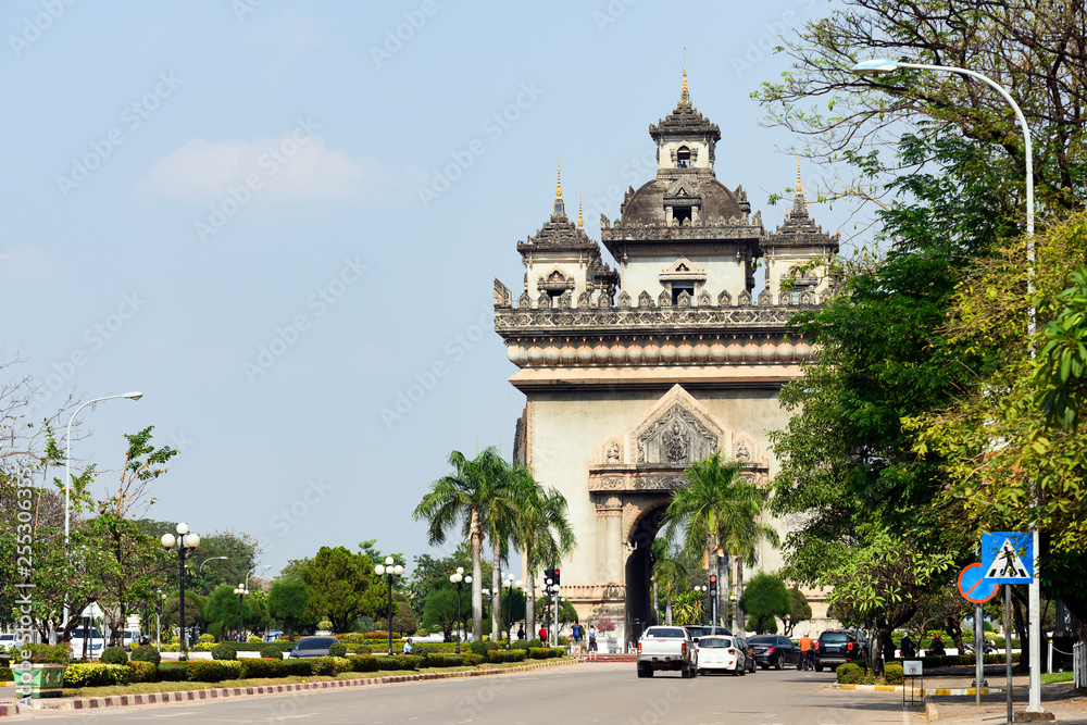 Stunning view of the beautiful Patuxai with daily traffic on the streets of Vientiane, Laos. Patuxai is a war monument in the centre of Vientiane, Laos, built between 1957 and 1968.