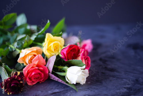 bouquet of colourful roses on black  grey background 