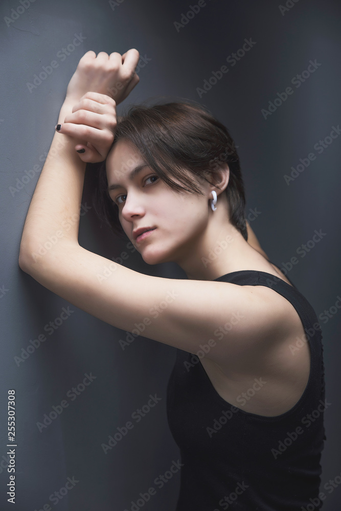 Portrait of an impulsive beautiful young girl with short hair in a black t-shirt and top Portrait of an impulsive beautiful young girl with short hair in a black t-shirt and top