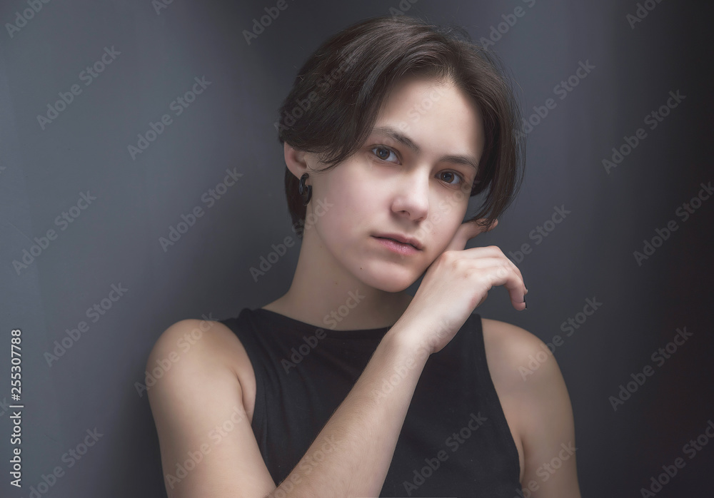 Portrait of an impulsive beautiful young girl with short hair in a black t-shirt and top Portrait of an impulsive beautiful young girl with short hair in a black t-shirt and top