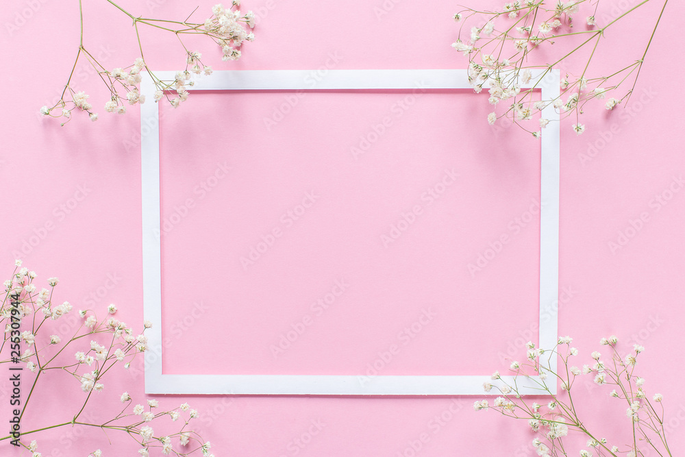 White frame with white flowers on a pink background