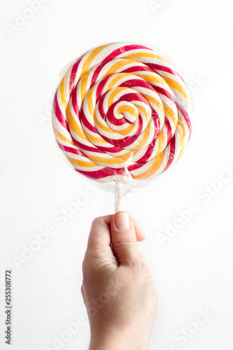 lollipop in hand on white background