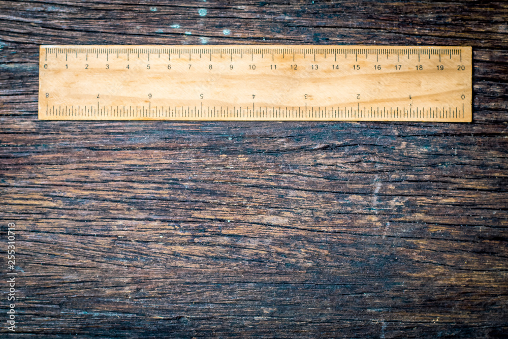 wooden rulers in centimeter and inch on old wood rustic background ...
