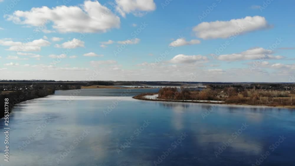 Lake view from above in Ukraine, with ice upon it. Beautiful blue sky with clouds Lake view from above in Ukraine, with ice upon it. Beautiful blue sky with clouds