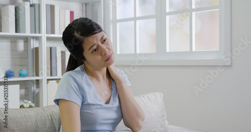 Pretty young woman feels neck pain while sitting on sofa in living room. Tired stressed female suffering from discomfort massaging tense shoulder muscles after long hours of work back to home resting Free Download Pretty young woman feels neck pain while sitting on sofa in living room. Tired stressed female suffering from discomfort massaging tense shoulder muscles after long hours of work back to home resting - GFXLoad