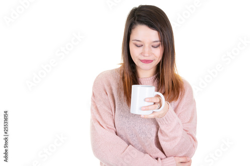 young woman with cup of coffee looks down pensive thinking