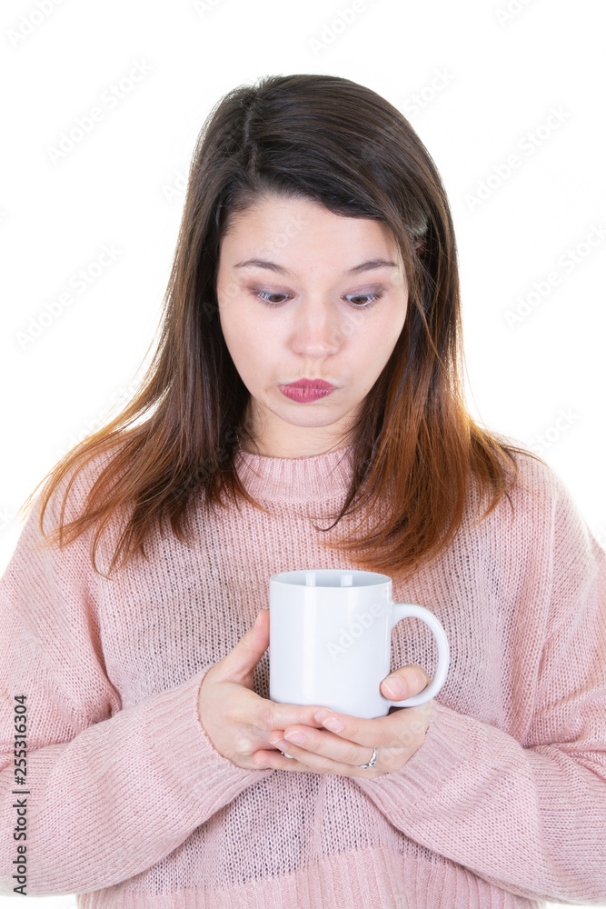 Young woman drinking cup of coffee over isolated white background serious fun face thinking Young woman drinking cup of coffee over isolated white background serious fun face thinking