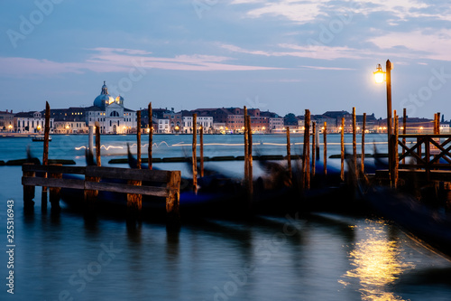 Evening view of gondolas on the wave and San Giorgio Maggiore, Venice, Italy