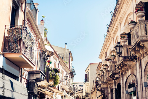 Beautiful cityscape of Italy, historical street of Taormina, Sicily, facade of old buildings.