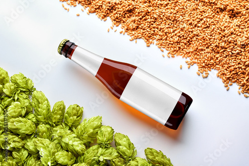 Brown beer mockup with diagonal placement bottlle on white background  with wheat and hops photo