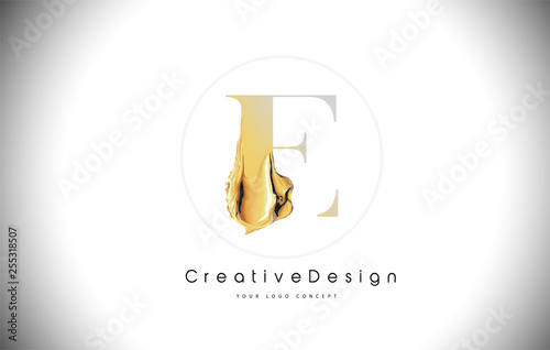 E Golden Letter Design Brush Paint Stroke. Gold Yellow e Letter Logo Icon with Artistic Paintbrush