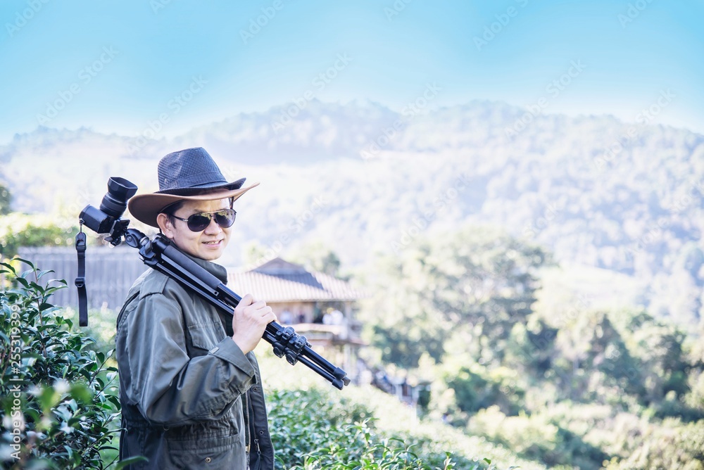 Fototapeta premium Photographer man in green tea field nature