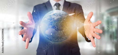 Businessman holding a 3d rendering particles earth globe