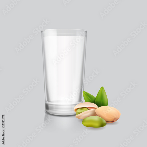 Drinking glass of milk with pistachio nuts