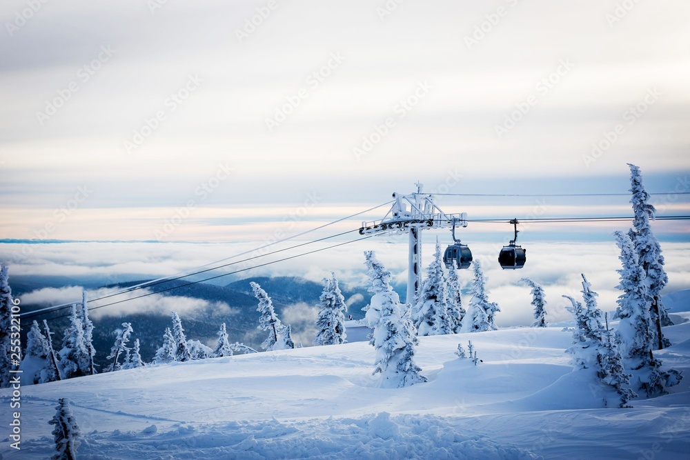 Snow-covered nature of Sheregesh with icy lift at the ski resort.