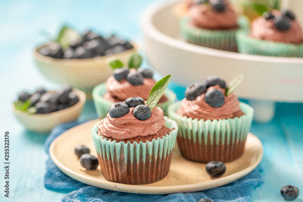 Fresh cupcake with blueberries and chocolate cream