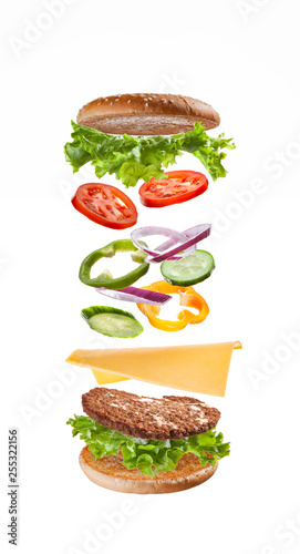  Delicious beautiful burger for a quick snack with flying ingredients.