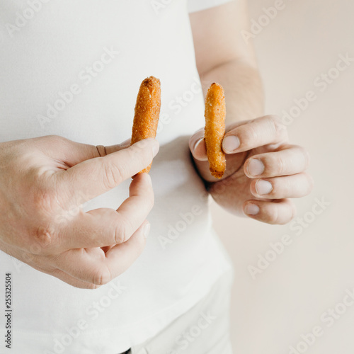 processed products, fast food, unhealthy diet, imbalanced ration. overweight man eating chicken nuggets