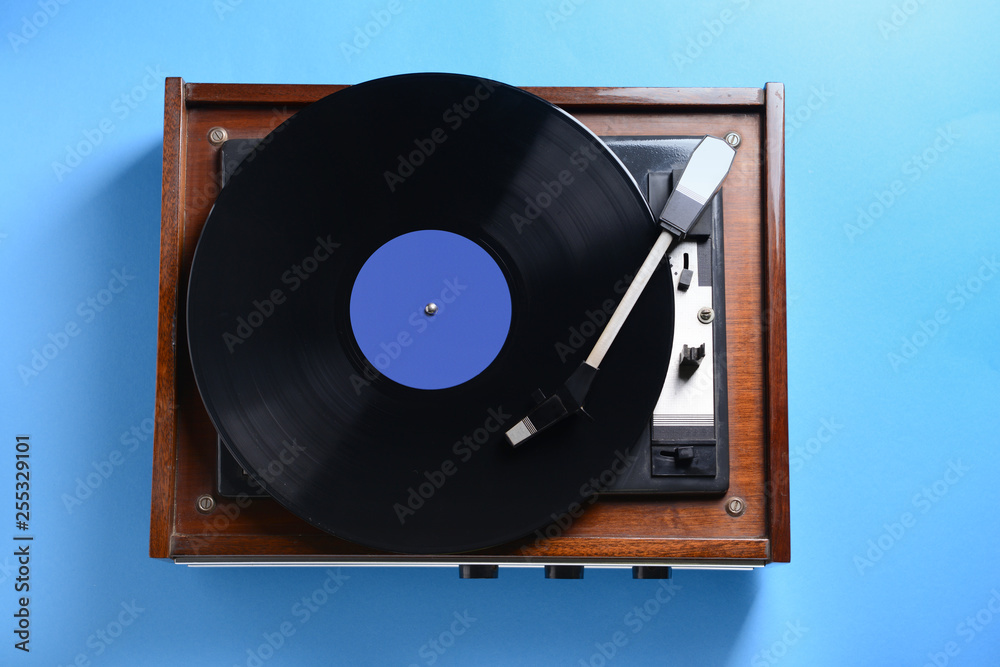 Obraz premium Record player with vinyl disc on color background