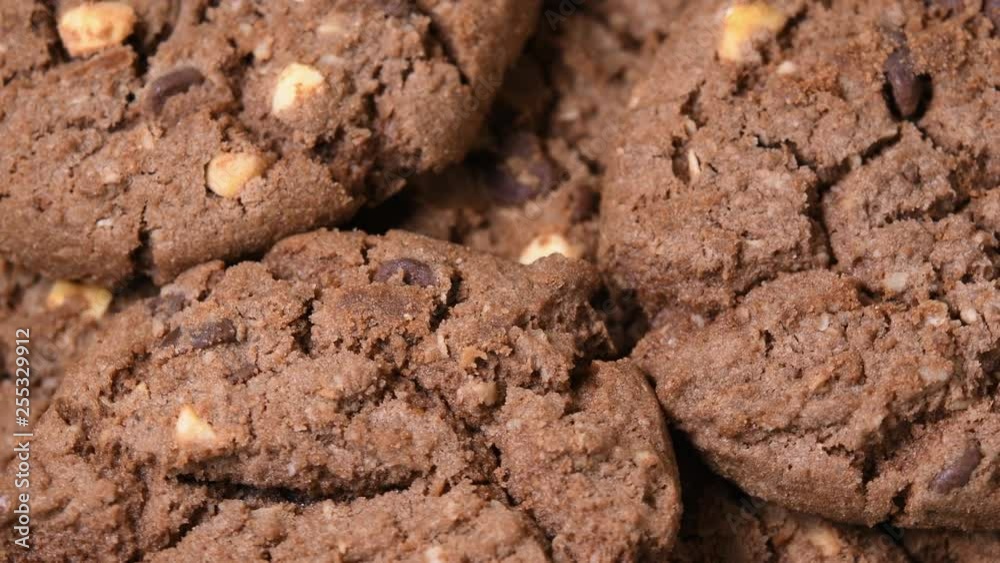 Oatmeal cookies with cocoa, chocolate and hazelnuts rotating close-up Oatmeal cookies with cocoa, chocolate and hazelnuts rotating close-up