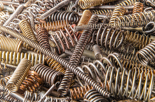 colored metal coil springs of different sizes. set of industrial springs. closeup