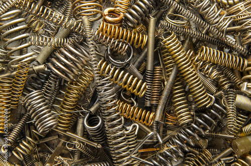 metal coil springs of different sizes. set of industrial springs. close up