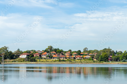 Houses and their reflection on the water at Parramatta River. Sydney, Australia.