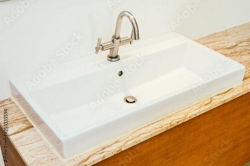 Faucet or water tap and white sink or washbasin decoration in bathroom
