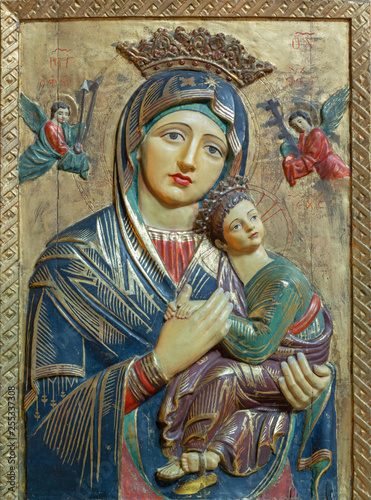 PALMA DE MALLORCA, SPAIN - JANUARY 26, 2019: The carved polychrome relief of Madonna (Our Lady of Perpetual Help) in church Iglesia de Santa Margarita by unknown artist. photo