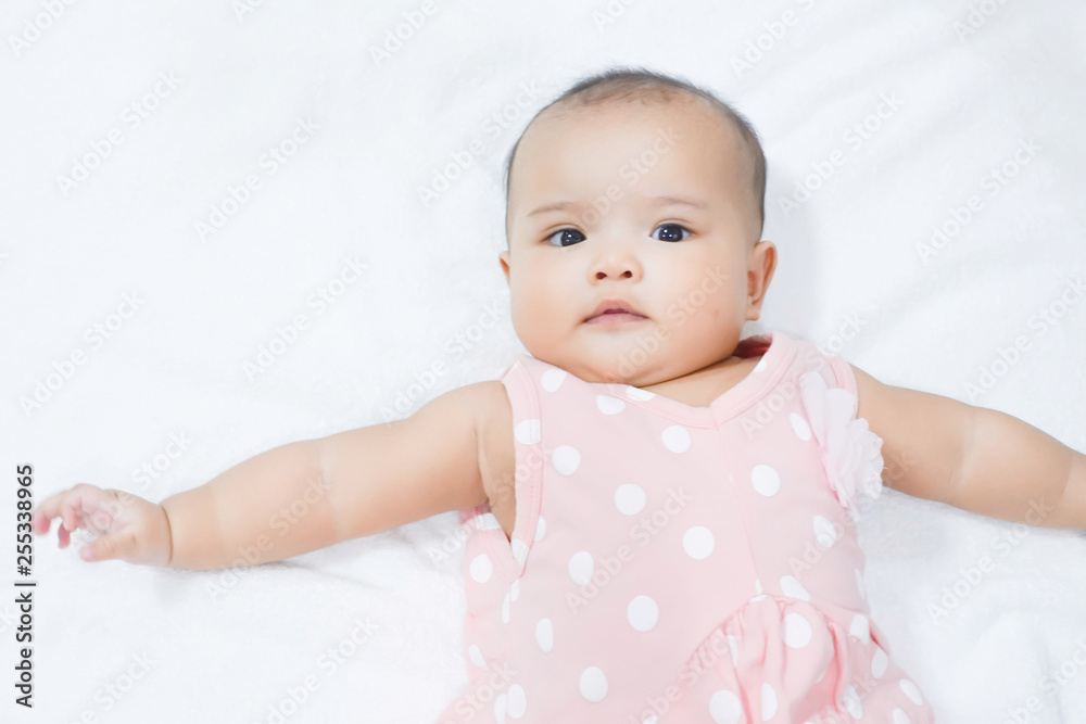 Asian newborn baby girl lying down on white bed Asian newborn baby girl lying down on white bed