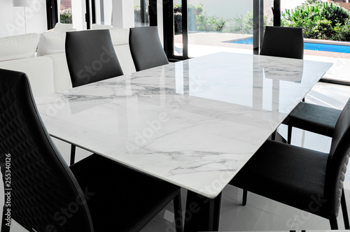 Obraz na płótnie Luxurious marble dining table with black chairs. w salonie